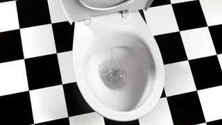 A toilet against a black and white floor – a place to learn UX lessons