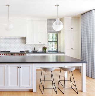 A kitchen with check pattern curtains