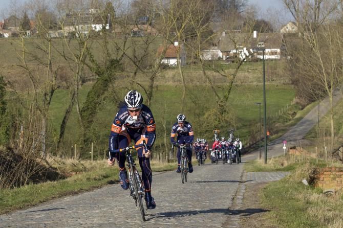Bobbie Traksel (Champion System) jumps away from his teammates on a sector of cobbles.