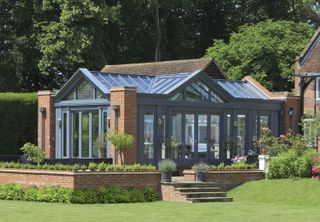 grey brick conservatory with pitched roof covering