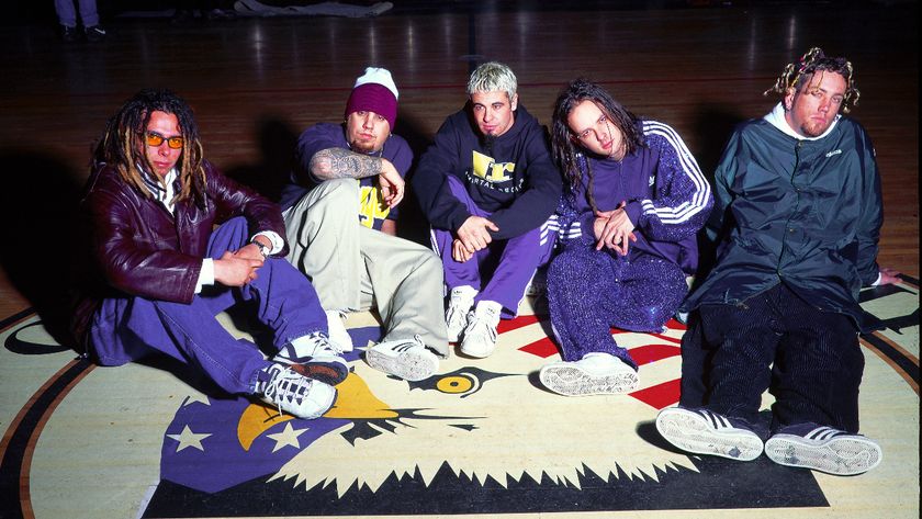 Korn sitting on a basketball court in 1996