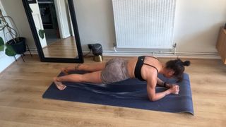 Writer Sam performing forearm plank at home on exercise mat