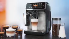 Philips 5400 Series LatteGo on a countertop with coffee around it