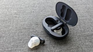 Ultimate Ears UE Fits review: earbud laying outside of the charging case