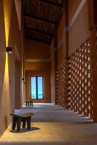perforated walls in Nigeria interior in earth brick barn house for Yinka Shonibare Foundation