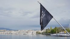 The Watches and Wonders 2024 flag over the Geneva skyline