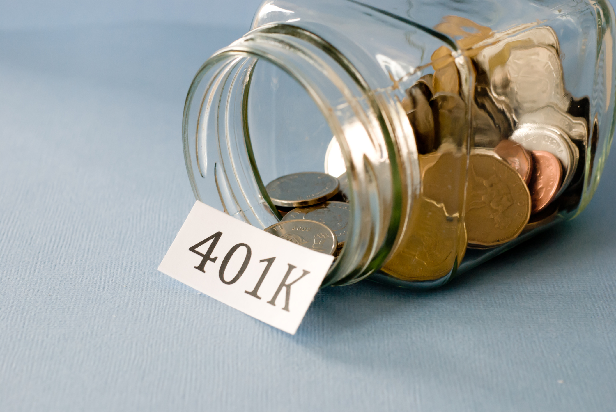 401k sign on a jar of ,coins