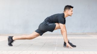 Man doing low lunge yoga move for running