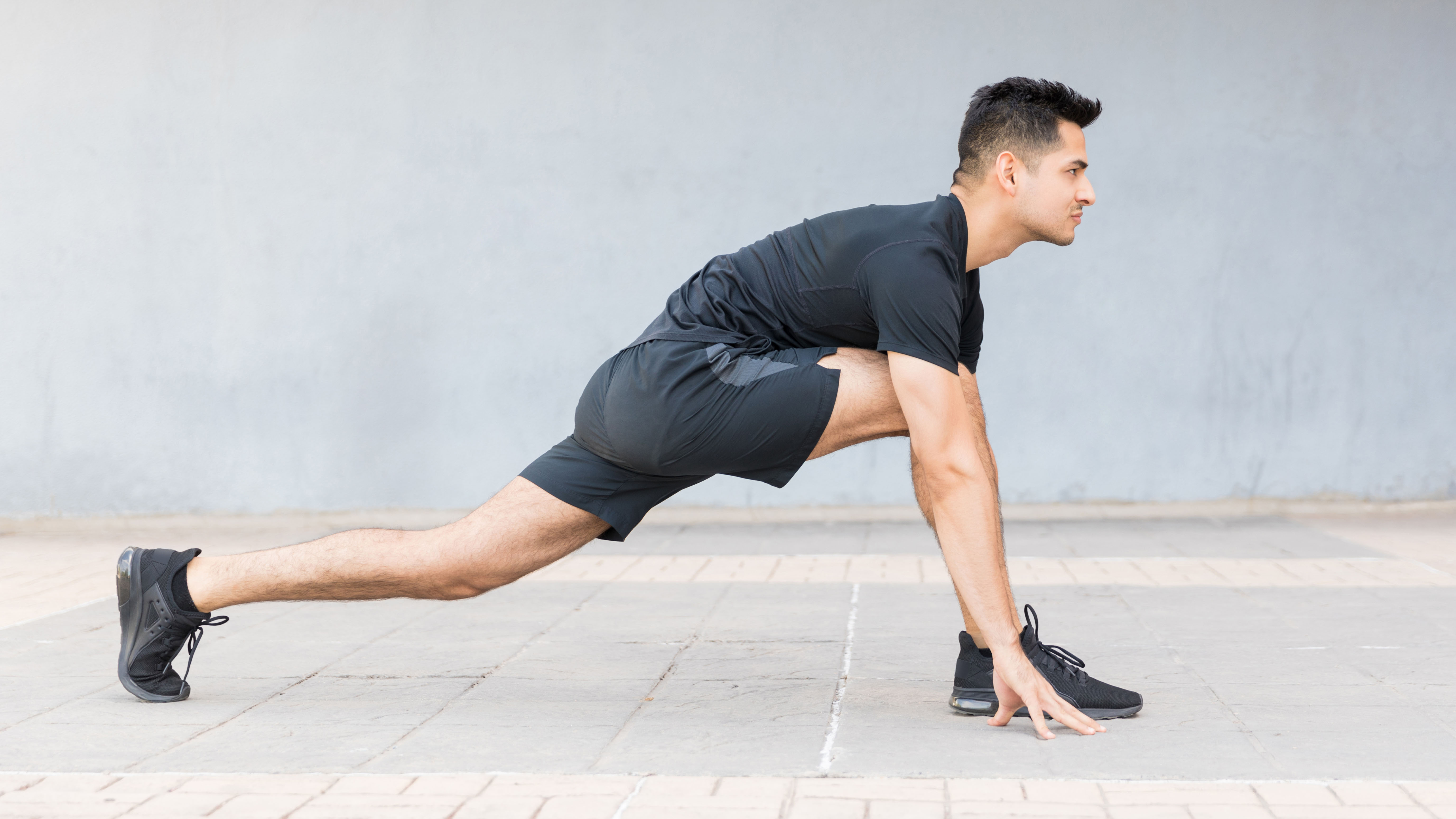 Man doing low lunge yoga for running