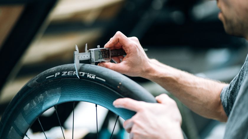 A man measuring the width of a tyre with calipers