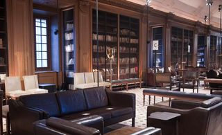 Library with brown leather sofas