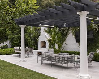 A pavilion area with outdoor sofa and chairs, and an outdoor fireplace