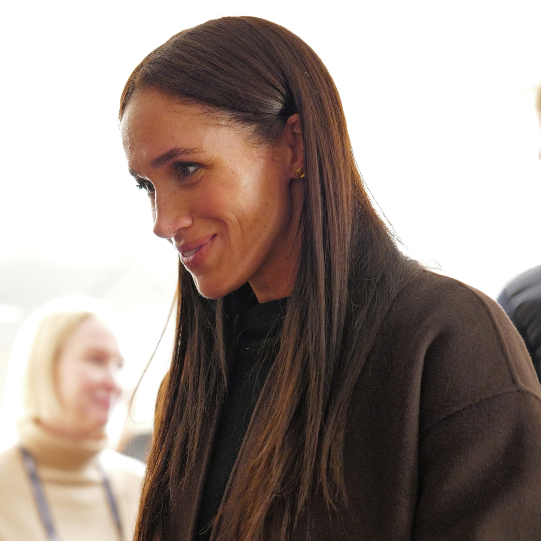 Meghan Markle poses wearing Mother black bootcut jeans and black sweater, and a brown cashmere coat, at the Salt Lake City celebration and premiere of "Cookie Queens" at Sundance Film Festival on January 24, 2026 in Salt Lake City, Utah