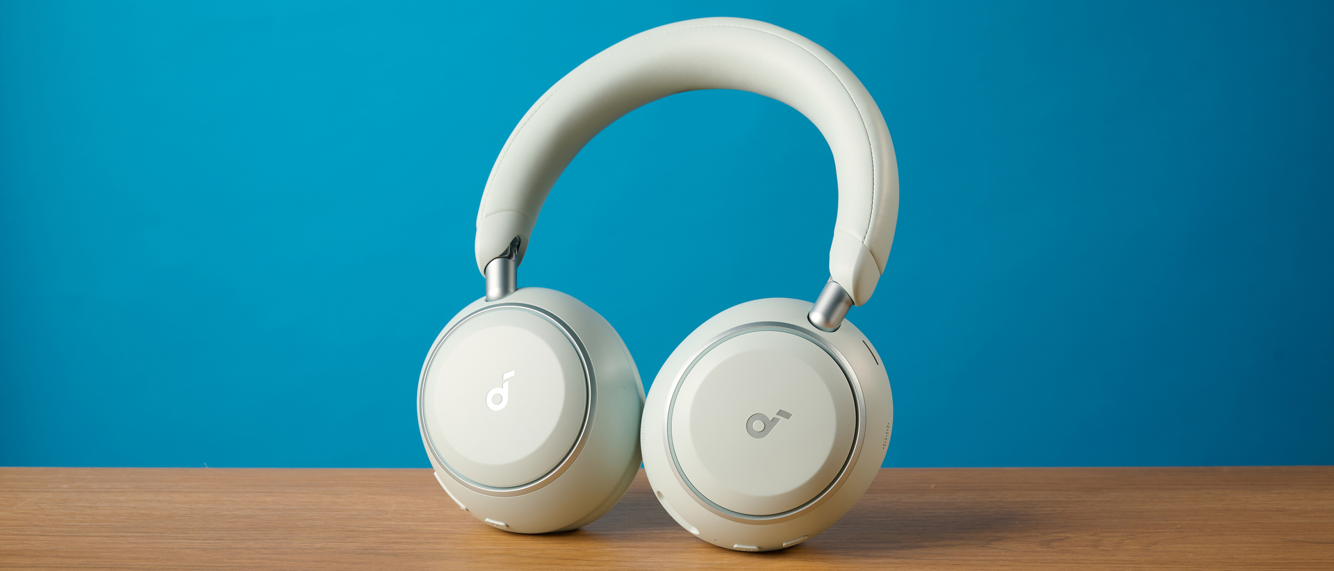 the soundcore space 2 headphones in white photographed against a blue tom's guide background