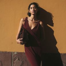 a model wearing an H&M burgundy dress