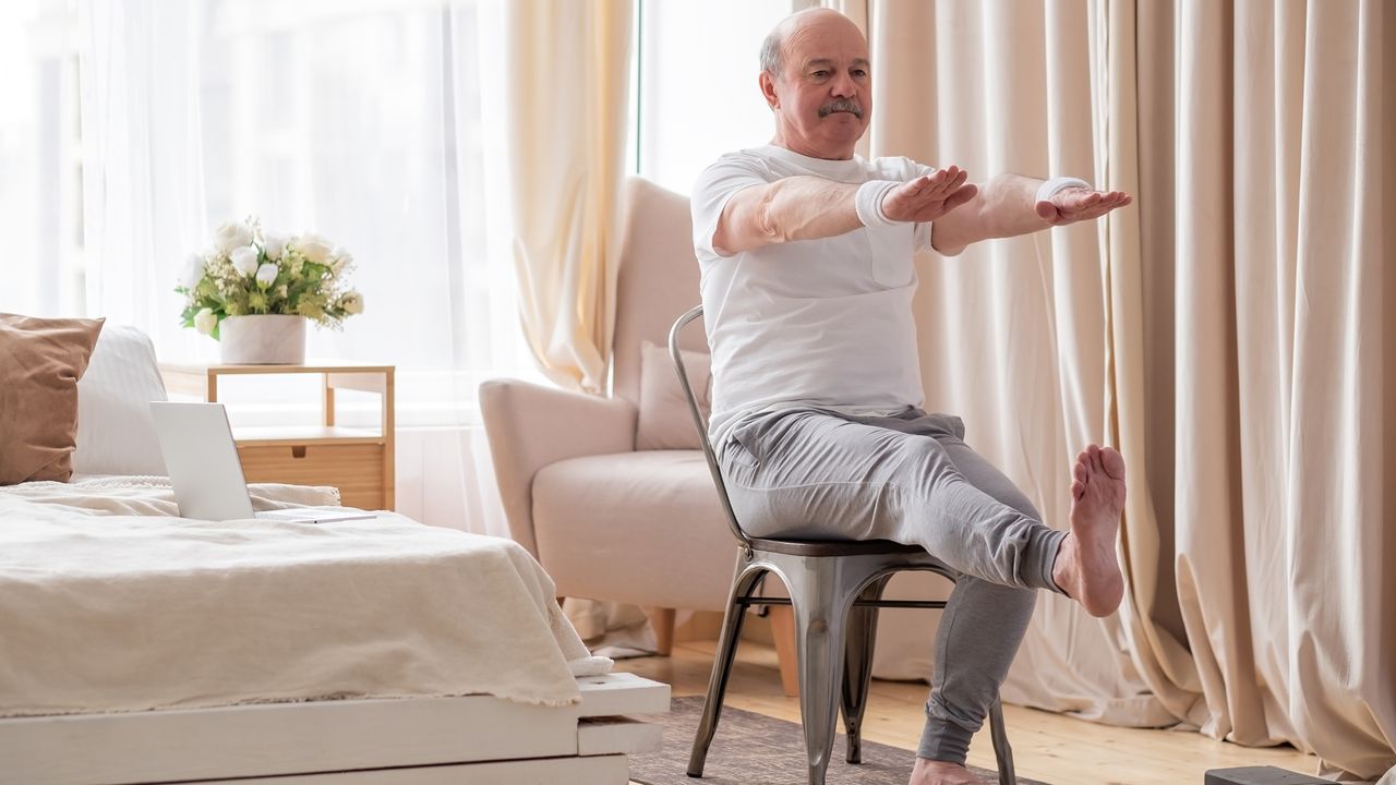 Senior man doing a chair workout