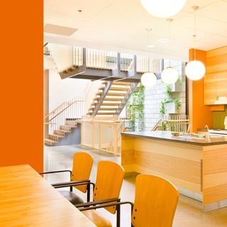 orange kitchen with dining table