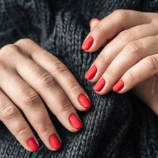 woman's hand with Red Painted Nails for winter
