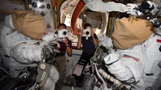 American astronauts Kayla Barron and Thomas Marshburn suiting up for a spacewalk.