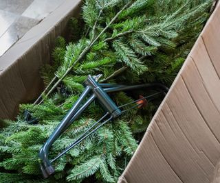 A christmas tree packed into a brown box