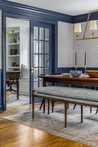 Dining room with dark blue trim and blue and white wallpaper