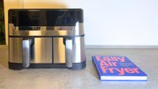 Jamie Oliver by Tefal Dual Easy Fry & Grill Air Fryer on the counter with the cookbook
