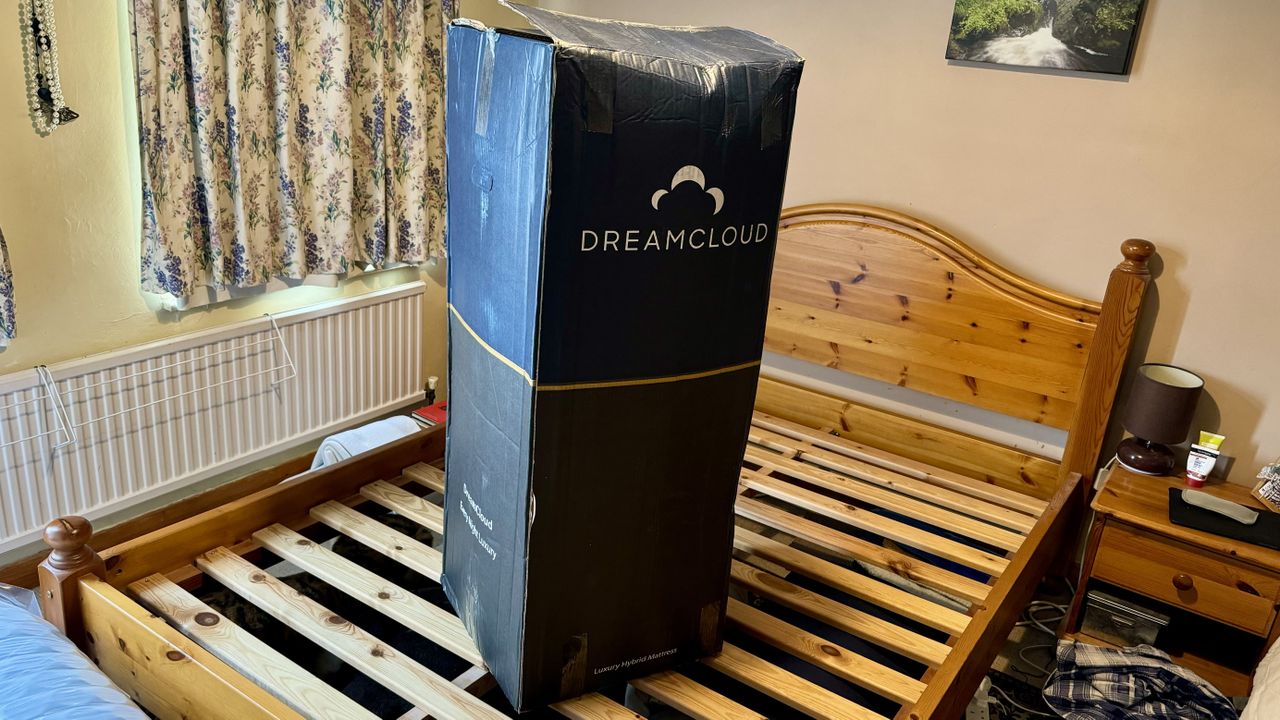 The image shows the DreamCloud Hybrid Mattress (UK) in a box on a bed