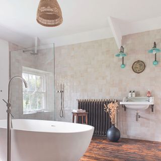 Bathroom with cream tiles, wood flooring and rattan light