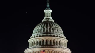 the white dome of the u.s. capitol building is lit up at night