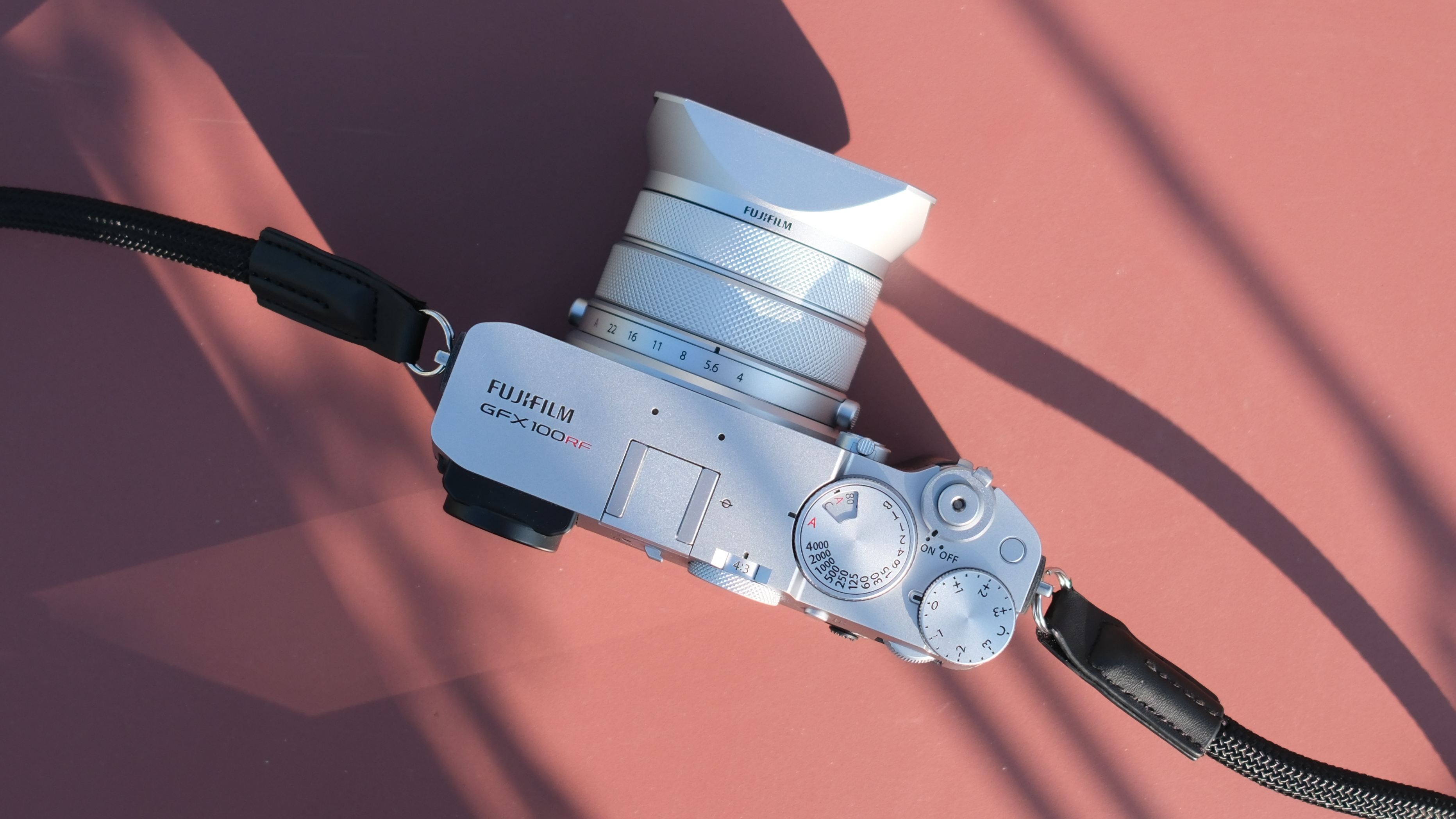 Fujifilm GFX 100RF camera on a red table in bright sunlight