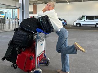 Caro Daur at the airport with suitcases.