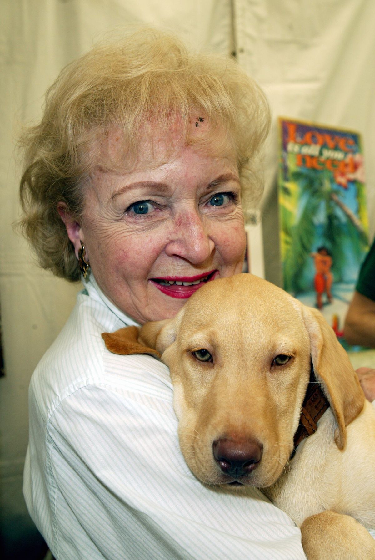 Betty White meets a puppy at the 9th Annual Safari Brunch at the Playboy Mansion in 2003