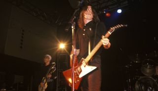 Pat Smear (left, background) and Dave Grohl (foreground) perform onstage with the Foo Fighters in 1995