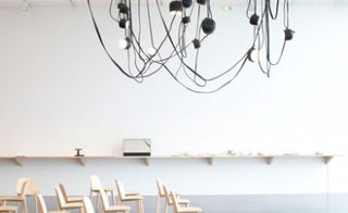 Hanging from the ceiling are the leather-clad ’Liane’ lights the Bouroullec brothers designed for Galerie Kreo in 2010