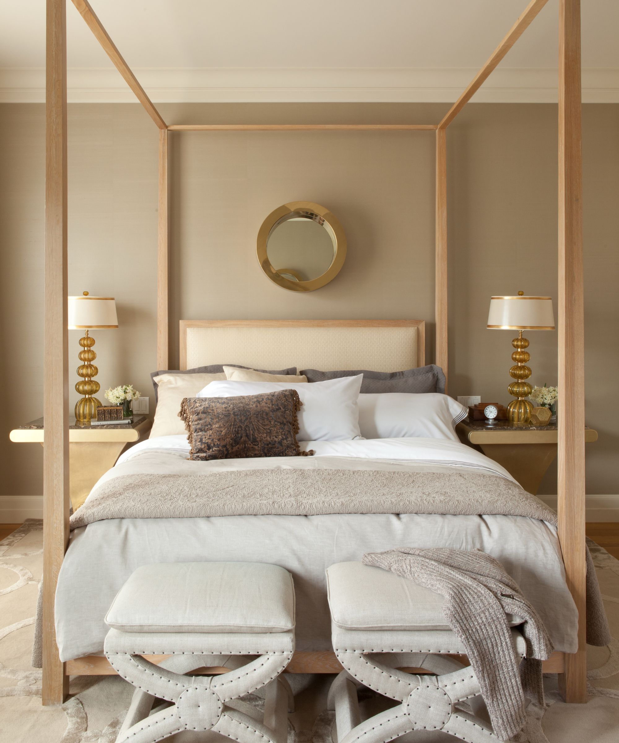 bedroom with pale wood four poster and neutral decor