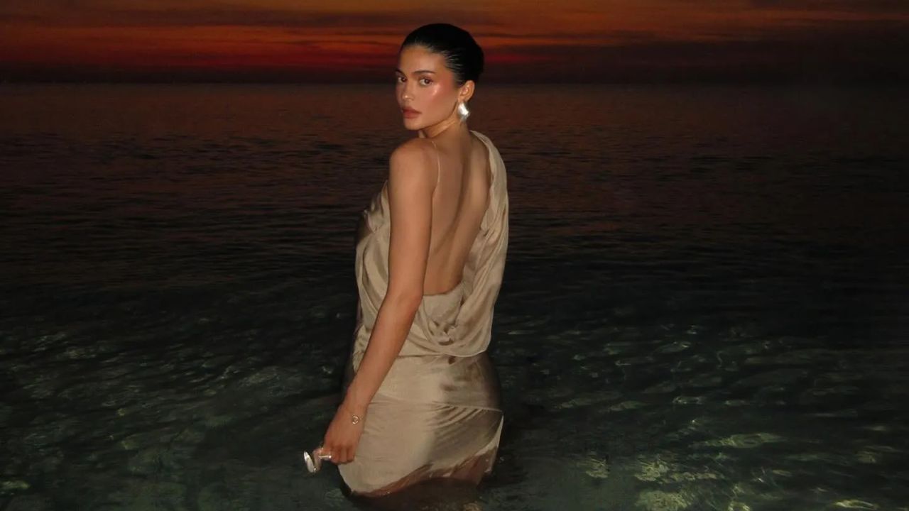 Kylie Jenner wearing a silver dress in the ocean in Turks and Caicos on Spring Break in April 2024