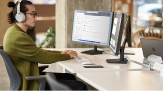 A sales person sat at a desk while using Microsoft's Viva Sales platform