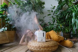 Woman laying next to a humidifier