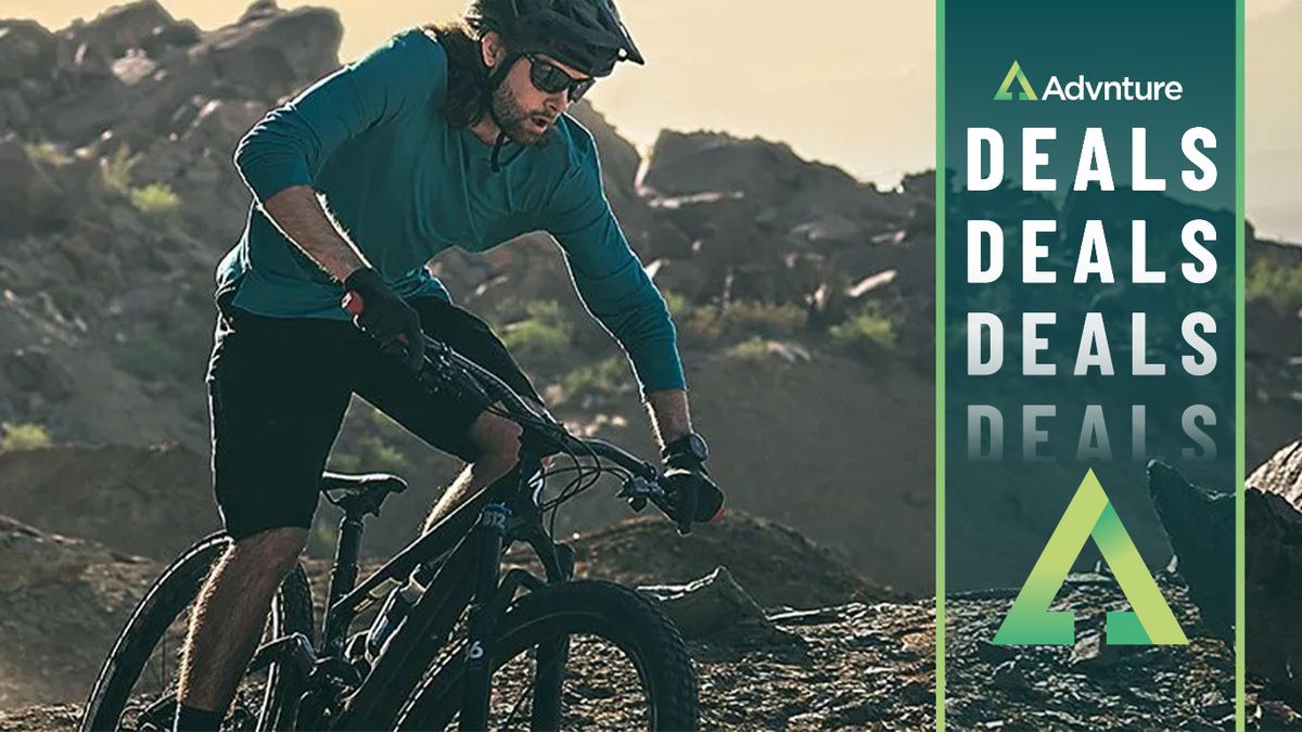 Man mountain biking wearing Garmin Fenix 7 Solar watch