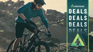 Man mountain biking wearing Garmin Fenix 7 Solar watch