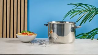 a black smart home enabled wi-Fi instant pot with a touchscreen and a 6QT inner pot is photographed against a blue background