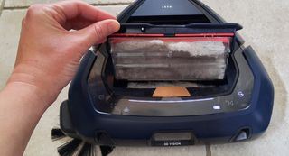 The inside of a robot vacuum displaying the dust it collects