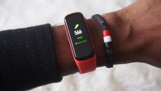 A Samsung Galaxy Fit 2 on someone's wrist, displaying a step count