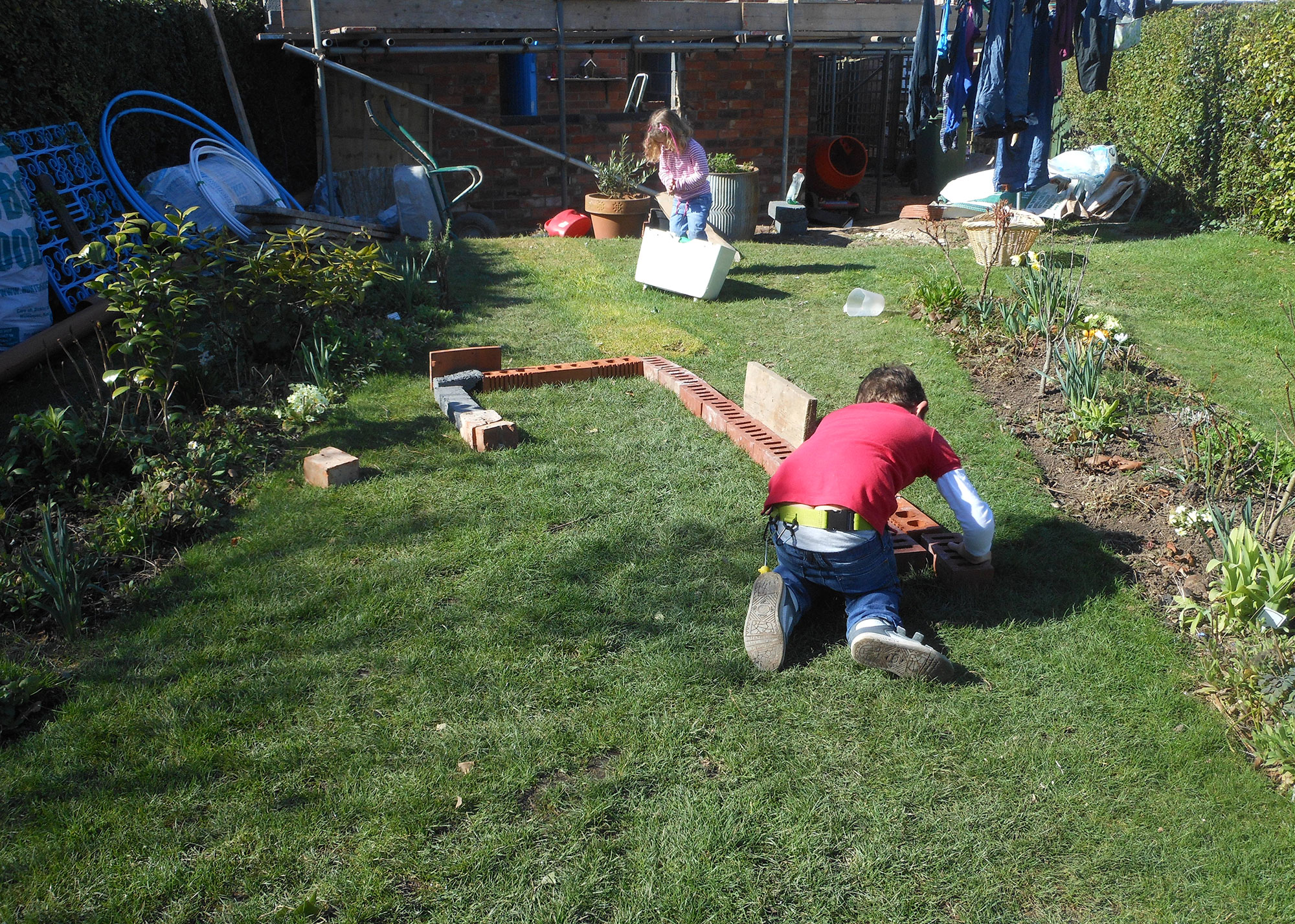 children playing in the garden of an extension project
