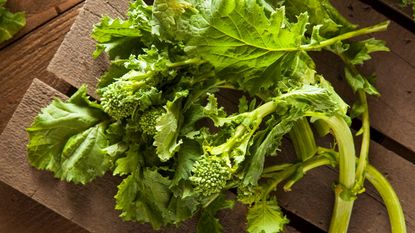 Harvested broccoli rabe on a wooden board