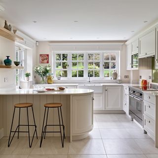 cream Shaker kitchen with belfast sink and curved breakfast bar