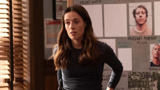 Burgess standing in front of the murder board in Chicago P.D. Season 13x07