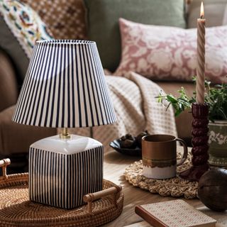 stripy table lamp on wicker tray