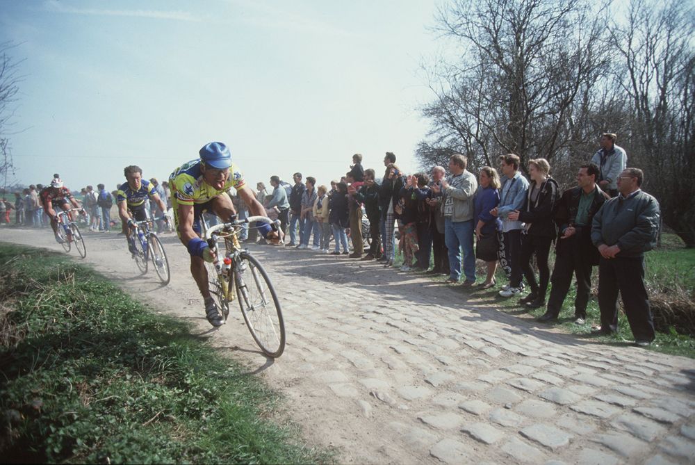 A rider from AKI races over the cobbles of Paris-Roubaix in 1996