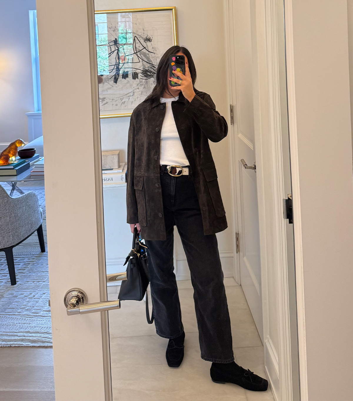 @nicoleakhtarzad taking a mirror selfie wearing a winter outfit.